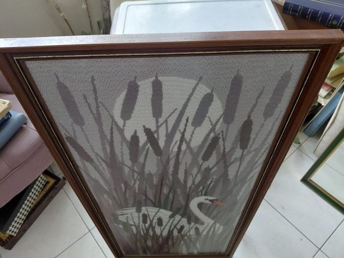 Vintage framed needlepoint tapestry depicting a white swan swimming