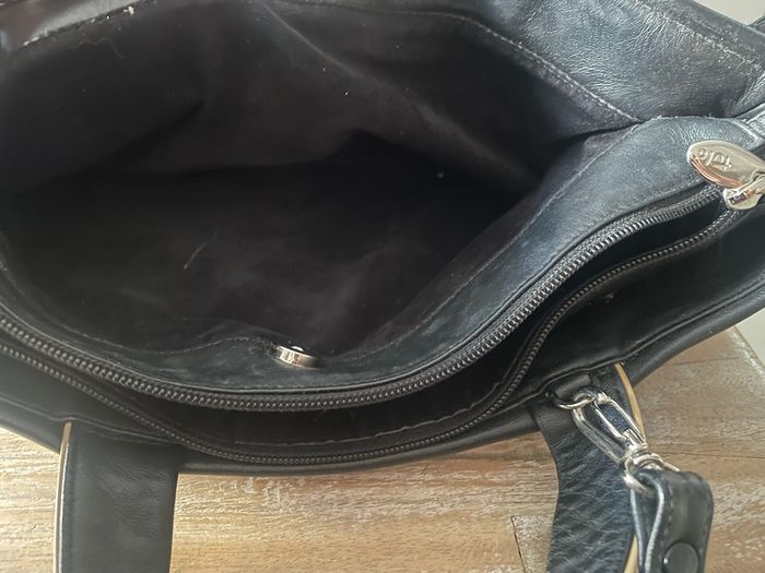Tula black leather tote bag with a shoulder strap.