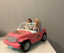Barbie car including a Ken and a Barbie.