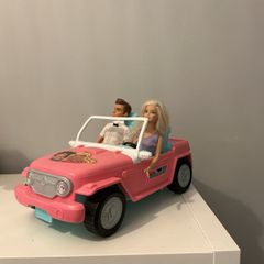 Barbie car including a Ken and a Barbie.