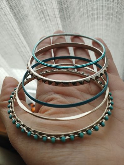 Charming bracelets in silver and blue tones.