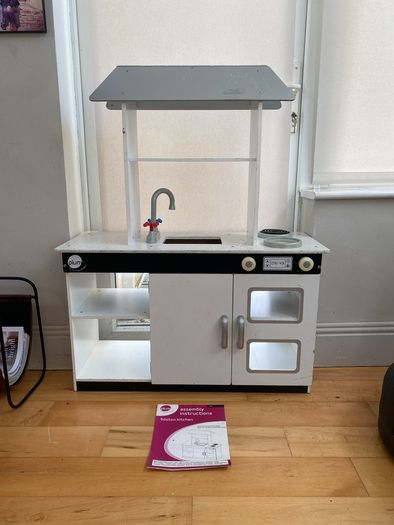 kids play kitchen by Plum with wooden food accessories