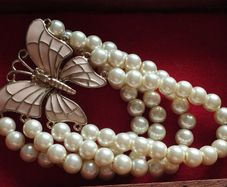 A beautiful faux pearl butterfly bracelet.