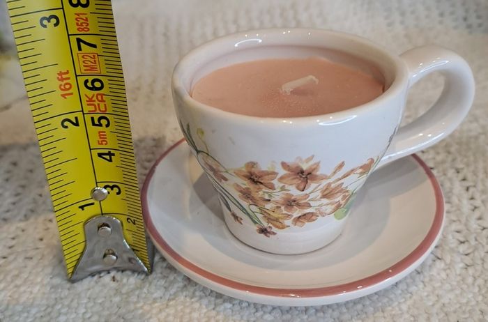Miniature vintage teacup and saucer with candle