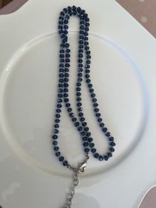 Blue bead crystal stone strung alongside small sterling spacers