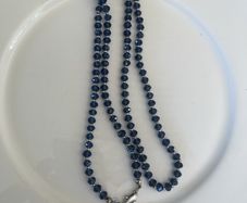 Blue bead crystal stone strung alongside small sterling spacers