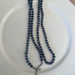 Blue bead crystal stone strung alongside small sterling spacers