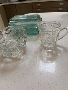 3 pieces of vintage table / dinner ware - A ribbed lidded glass butter dish , vintage 3 footed sugar bowl and cut glass milk jug