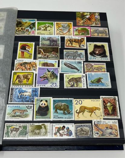 Ace Black 32 page/ 16 leaf Stamp Album with over 900 stamps. Thematic of Animals, Plants, Classic Cars, Space, Trains, Sport & Disney noted.