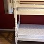 White wooden bunk beds with mattresses Image 2