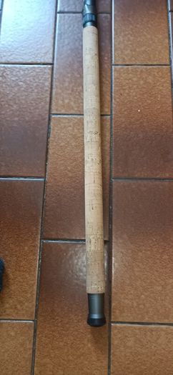 Shakespeare Agility Spin fishing rod. 11 feet (3.30 meters) in length. The item includes a black carrying tube with a strap for transport.