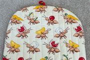 quilted cotton tea cosy featuring a playful ant and picnic food print