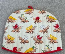quilted cotton tea cosy featuring a playful ant and picnic food print