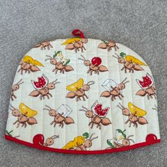 quilted cotton tea cosy featuring a playful ant and picnic food print