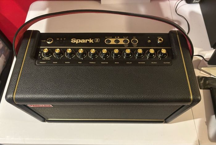 Positive Grid Spark 2 Smart Guitar Amp Bluetooth Speaker, Black with additional battery and carry bag.