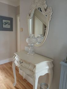 Cream French style hall table with one drawer and matching mirror.