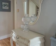 Cream French style hall table with one drawer and matching mirror.