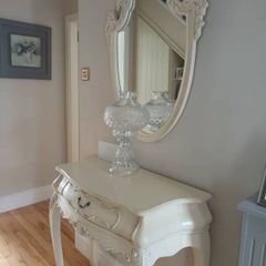 Cream French style hall table with one drawer and matching mirror.