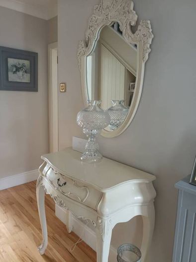 Cream French style hall table with one drawer and matching mirror.