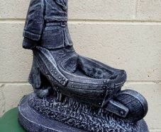 Man holding a wheelbarrow garden gnome planter