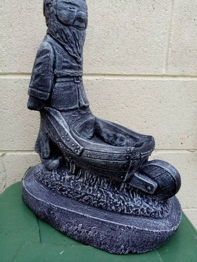Man holding a wheelbarrow planter