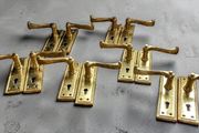 6 pairs of polished brass door handles
