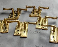 6 pairs of polished brass door handles