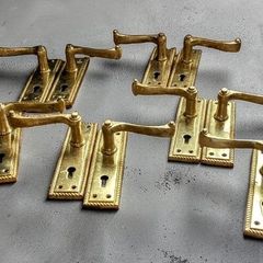 6 pairs of polished brass door handles