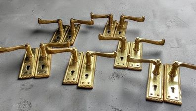 6 pairs of polished brass door handles
