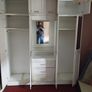 Double bedroom wardrobe with drawers and mirror in-between wardrobes and plenty of storage above Image 3