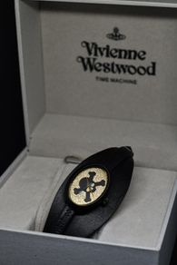 A Vivienne Westwood watch with gold face and leather strap
