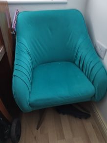 teal swivel chair with brass legs