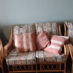 Lovely traditional cane/rattan-style three-piece suite with beautiful floral upholstery