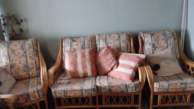 Lovely traditional cane/rattan-style three-piece suite with beautiful floral upholstery
