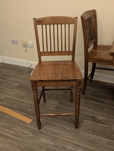 Wooden dining table with tiled top and matching chairs