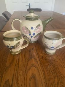 Pottery tea pot and a pair of matching mugs