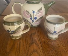 Pottery tea pot and a pair of matching mugs