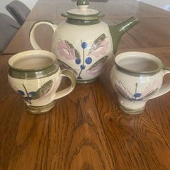 Pottery tea pot and a pair of matching mugs