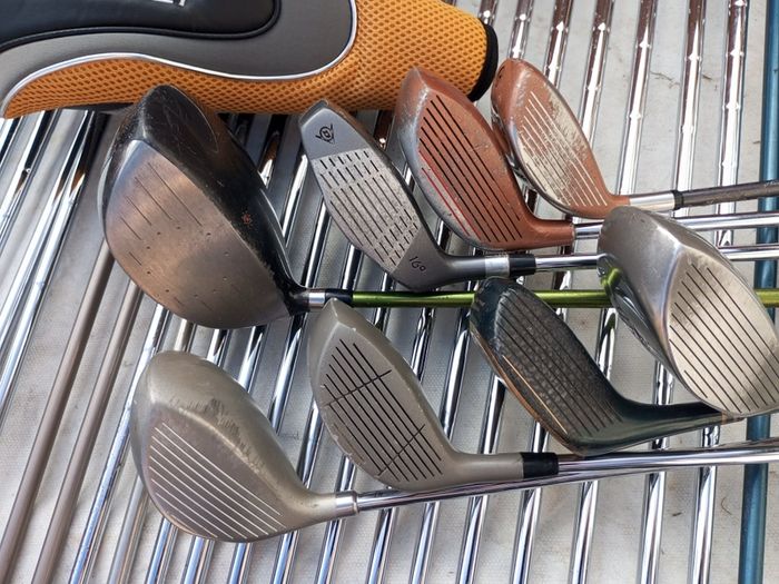 A selection of golf clubs and bags. All right handed clubs.