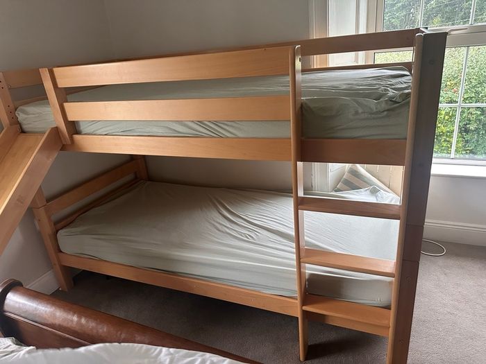 Bunk bed with attached slide and mattresses