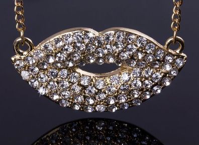 Gold tone kiss necklace