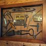 vintage shadow box containing a mix of antique tools, keys, and a loom. Image 7