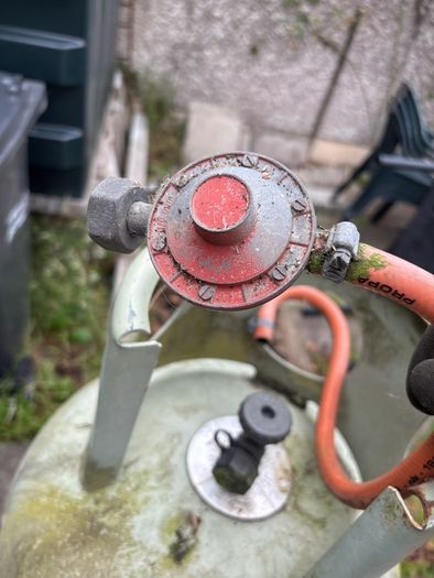 Empty 47kg propane gas cylinder and connection