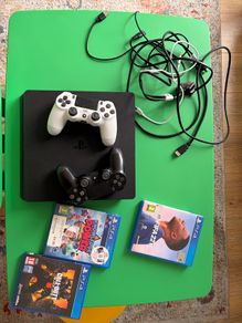 playstation 4 with two controllers and games