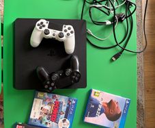 playstation 4 with two controllers and games