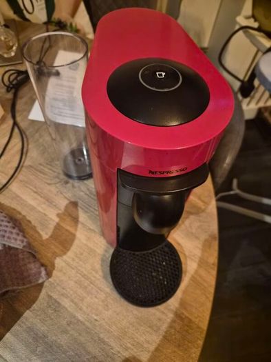 nespresso vertuo plus machine and coffee pods with holding tray