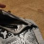 River Island clutch purse featuring a dual-texture gray flap panel design and a central dark metallic logo plate. Perfect inside. Image 8
