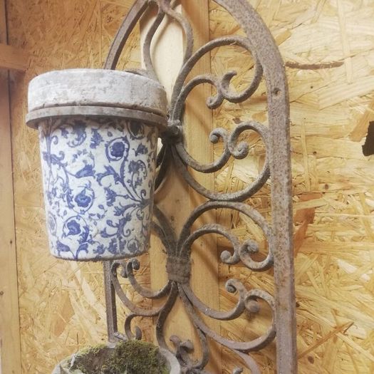 Vintage wrought iron plant hangers. Porcelain containers