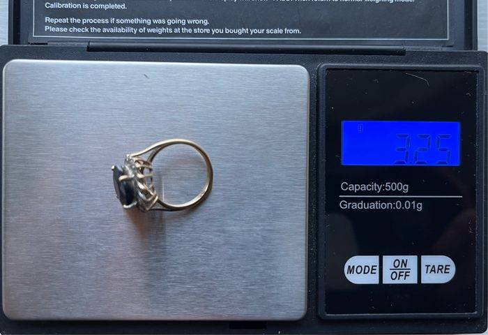 9ct Gold ring with a large sapphire and diamonds