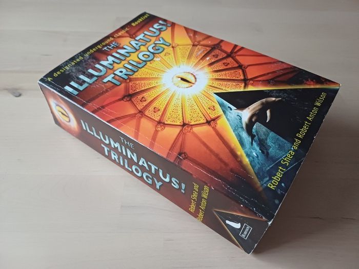 The Illuminatus Trilogy by Robert Anton Wilson (Science Fiction Conspiracy Paperback 1998)
